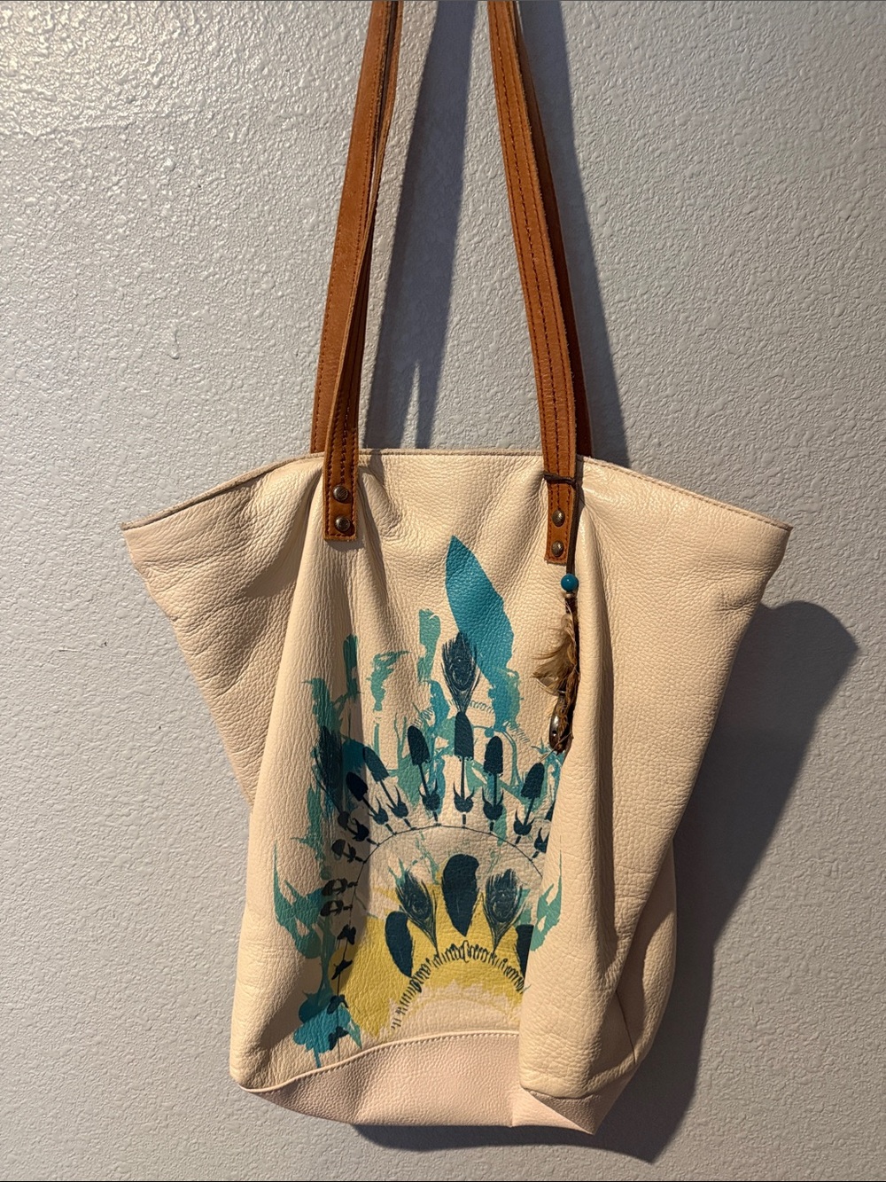 The Sak Cream Leather Tote Bag with Turquoise Feather Print